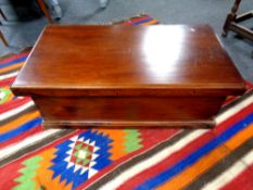 A reproduction hardwood blanket box