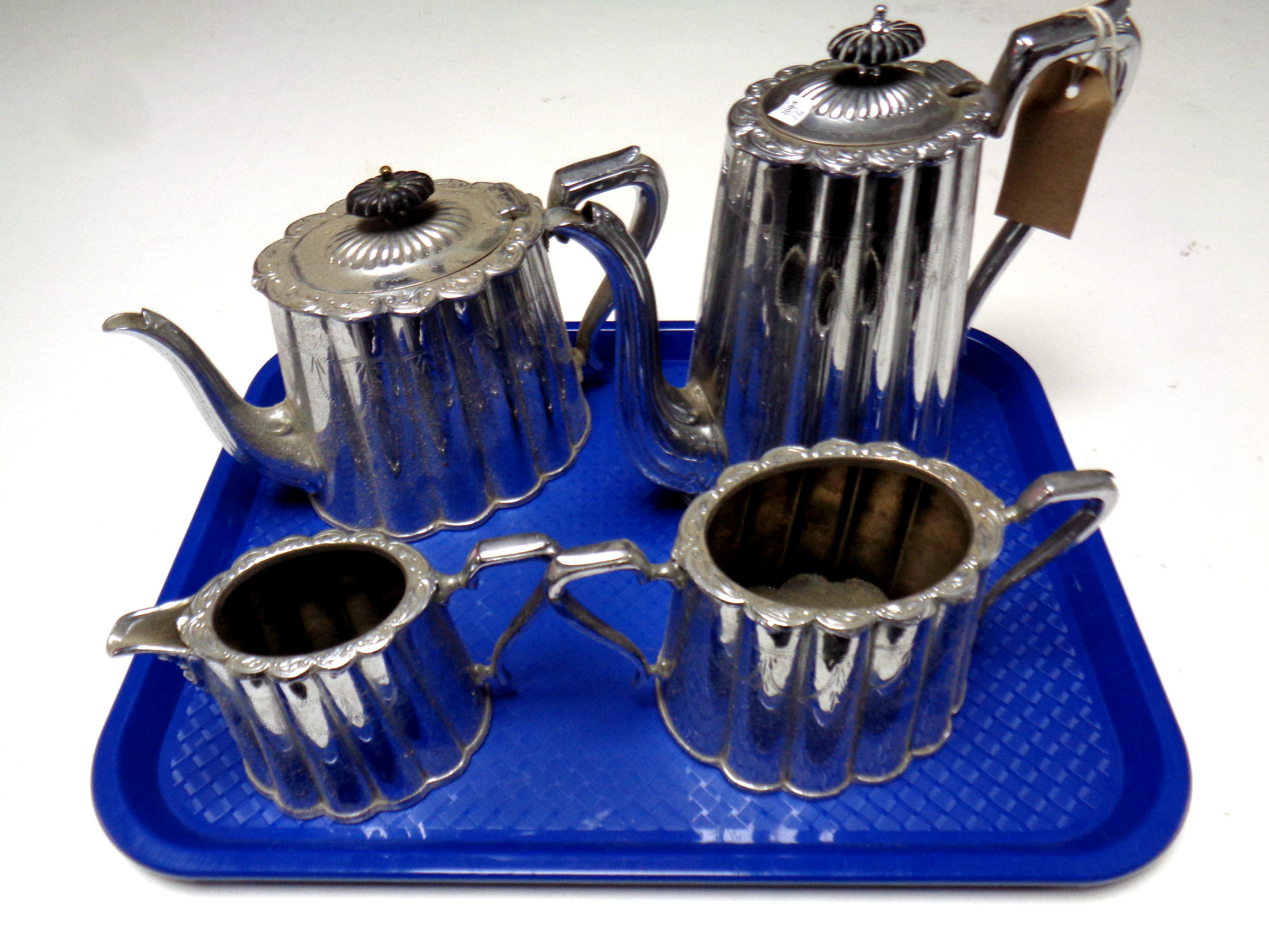 A tray containing a four piece plated tea and coffee service
