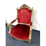 A French style gilt wood armchair upholstered in a red velvet fabric