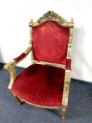 A French style gilt wood armchair upholstered in a red velvet fabric