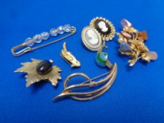 A quantity of costume brooches