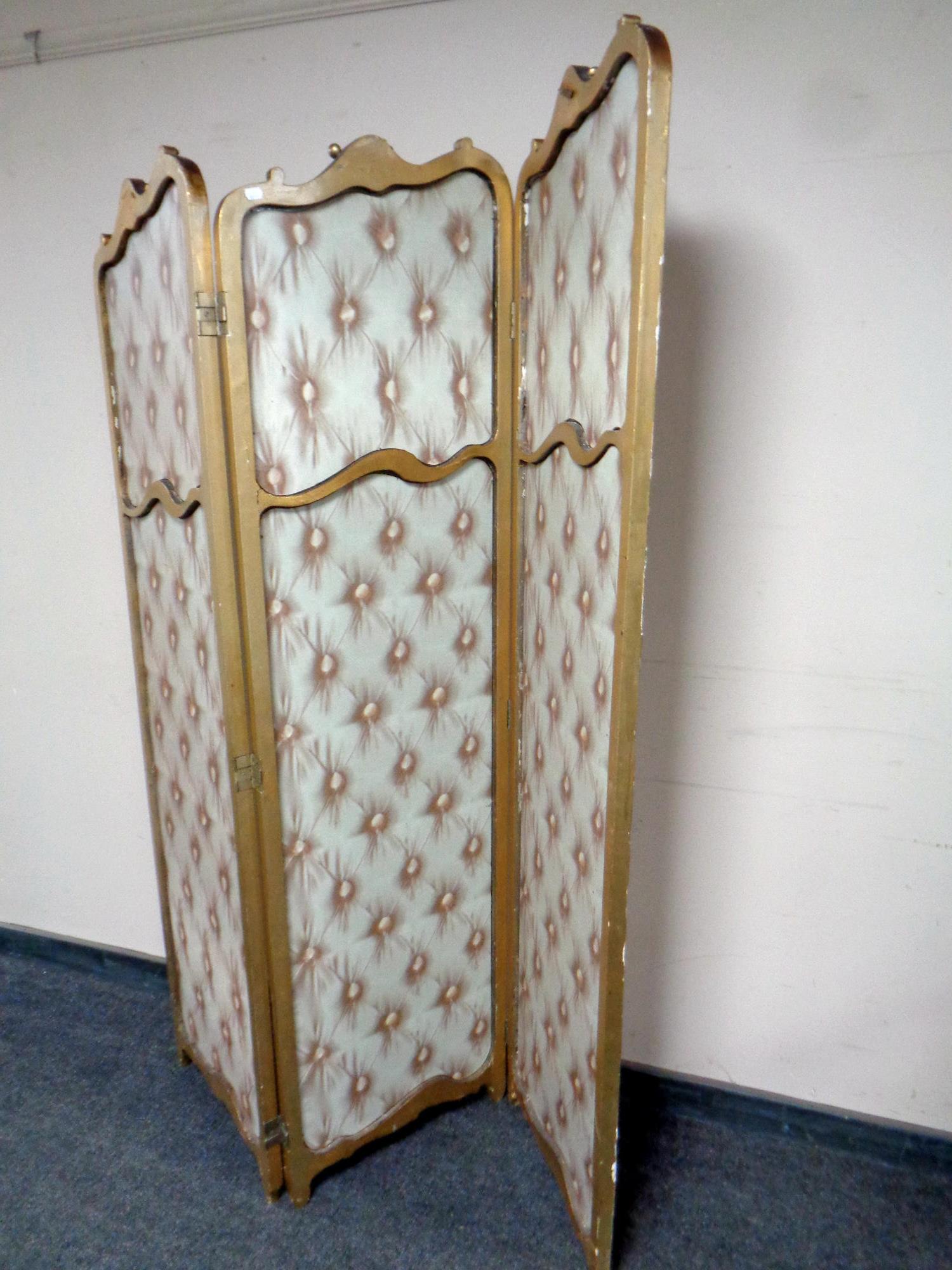 A gilt wood three way folding screen