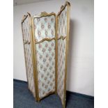 A gilt wood three way folding screen