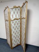 A gilt wood three way folding screen