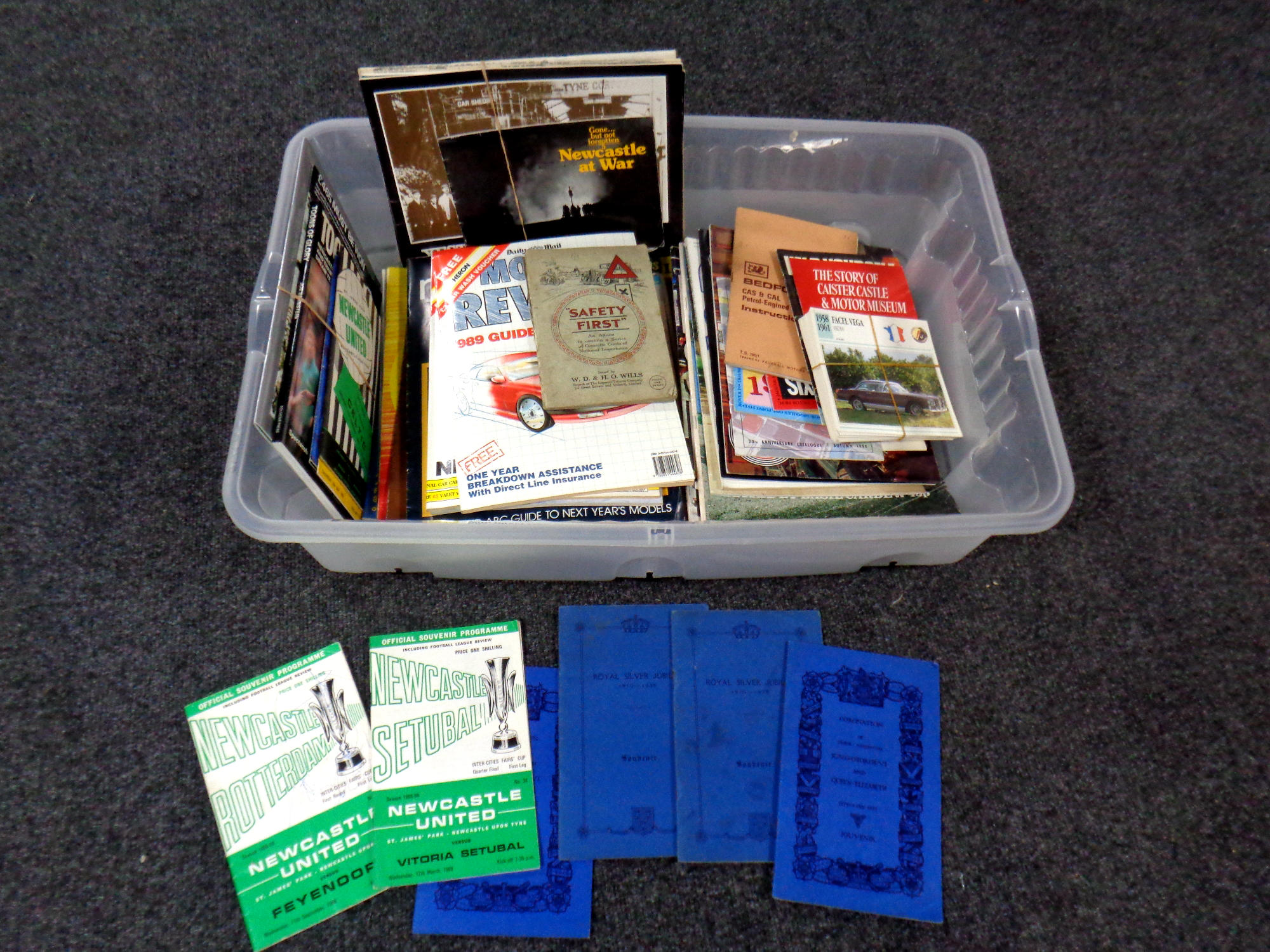 A box containing Newcastle United football programmes, car magazines, Coronation booklets,