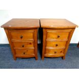 A pair of contemporary pine three drawer bow fronted bedside chests