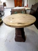 A circular garden table on chimney pot base