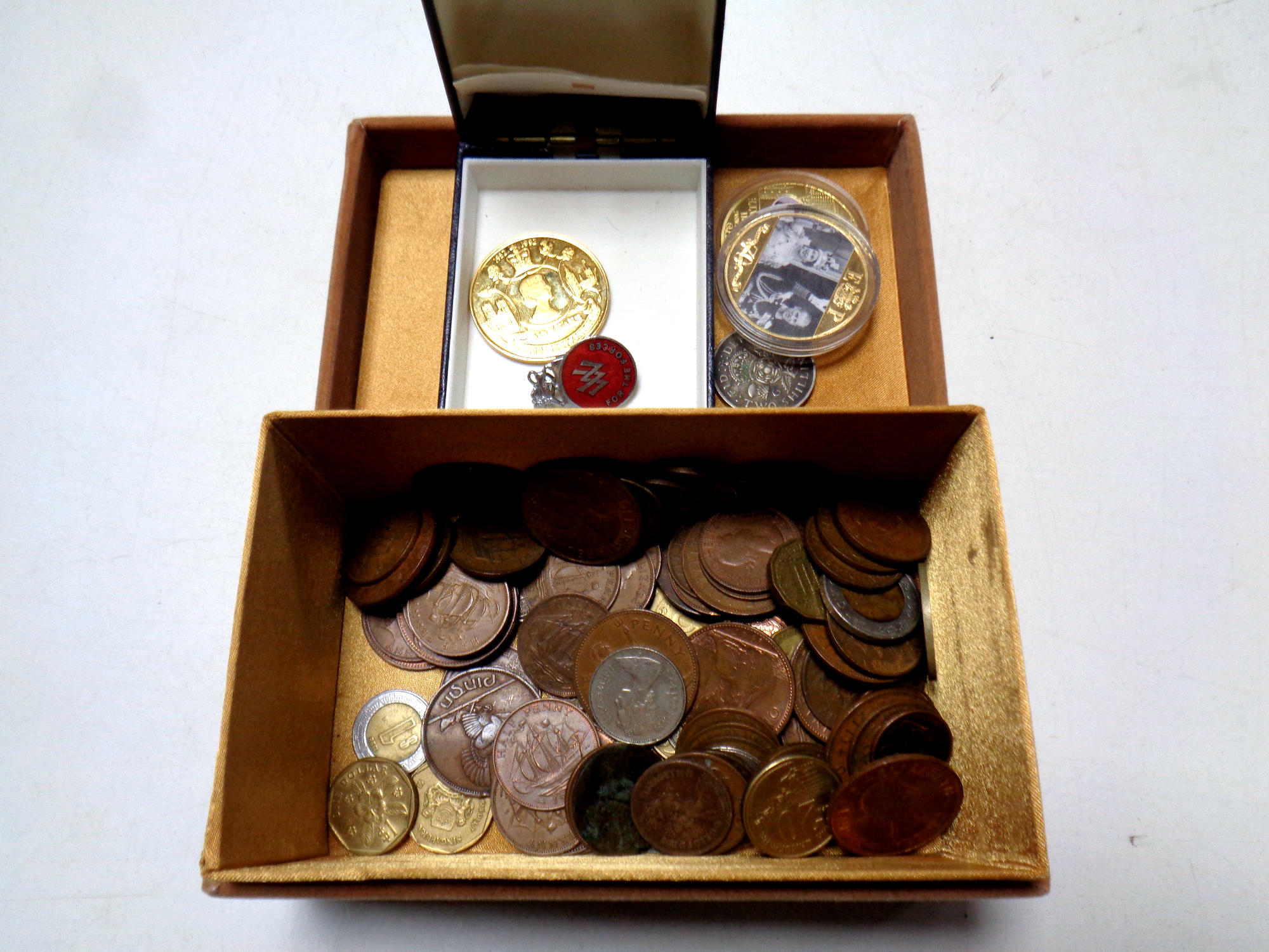 A box containing a small quantity of pre decimal coinage and Queen Elizabeth II commemorative gilt