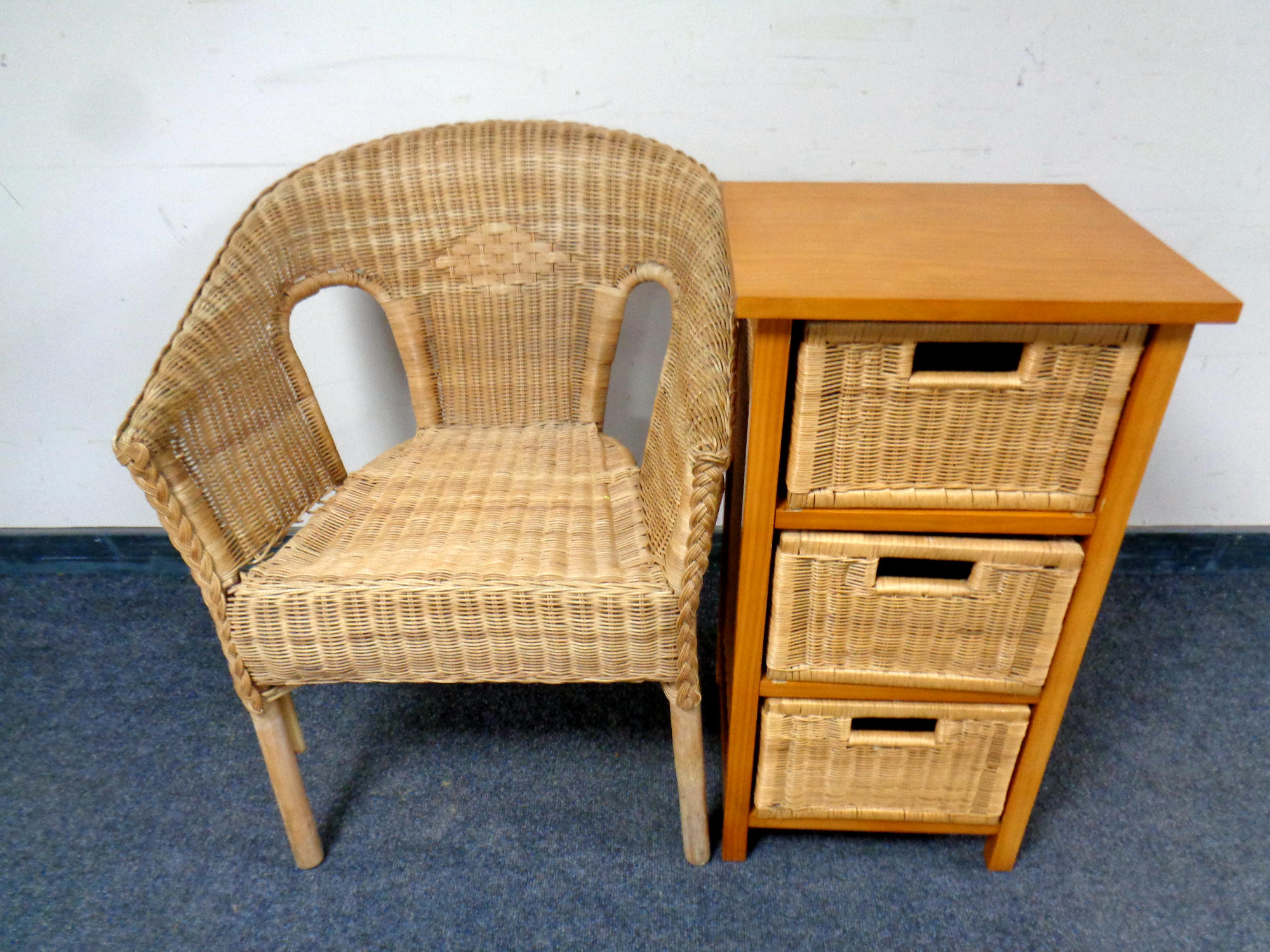 A pine and wicker three drawer chest together with a wicker armchair