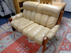 A wood framed two seater settee upholstered in a mustard leather