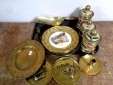 A tray containing assorted brass ware to include brass embossed plaques, three lidded caddies,