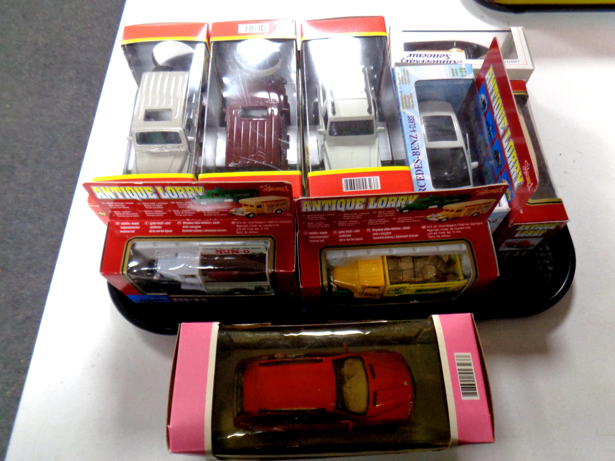 A tray containing die cast vehicles to include antique lorries, Newray, Toyota, Land Cruiser,