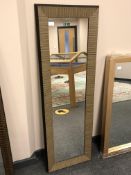 A contemporary wood effect mirror,