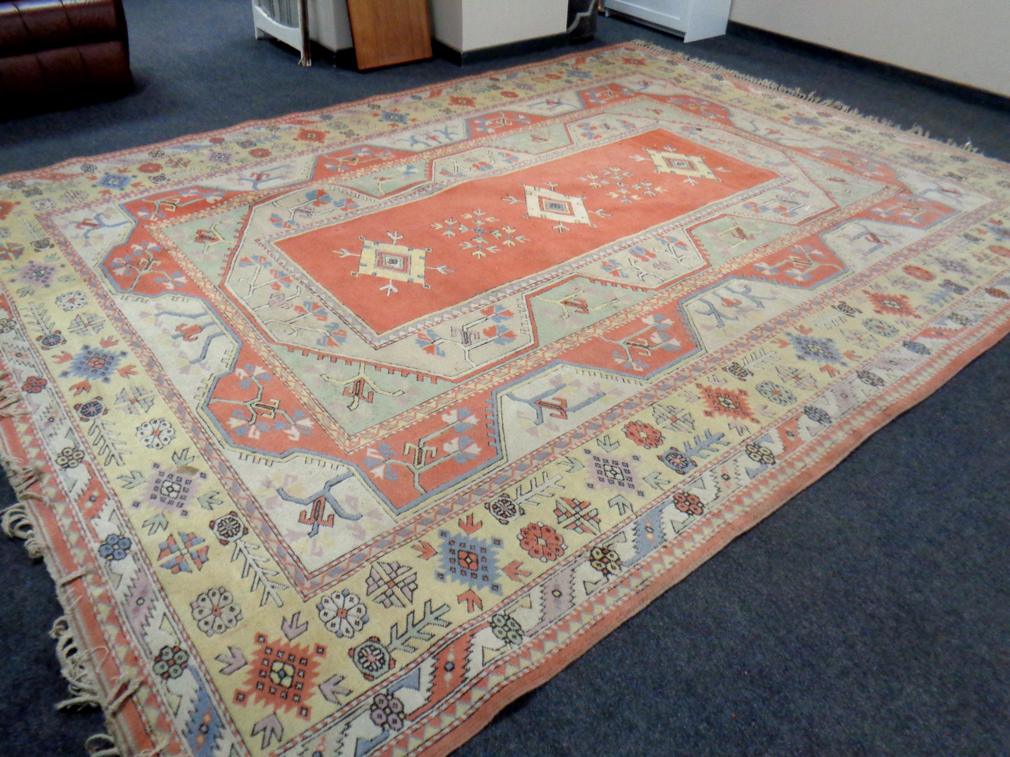 A Melas carpet, Western Anatolia, with peach central field of stylised medallions,