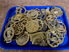 A tray containing a quantity of horse brasses