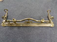 An antique brass Art Nouveau fire fender