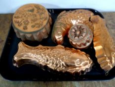 A tray containing five vintage copper jelly moulds