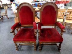 A pair of Edwardian oak high backed armchairs upholstered in a maroon dralon