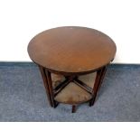 A 20th century circular occasional table fitted four tables beneath