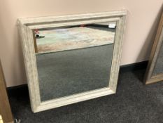 A modern mirror in a distressed frame,