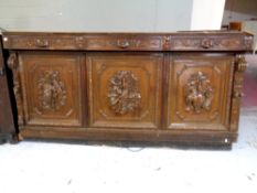 An antique continental profusely carved oak bar front,