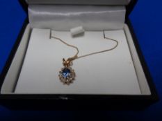 A 9ct gold diamond and sapphire pendant