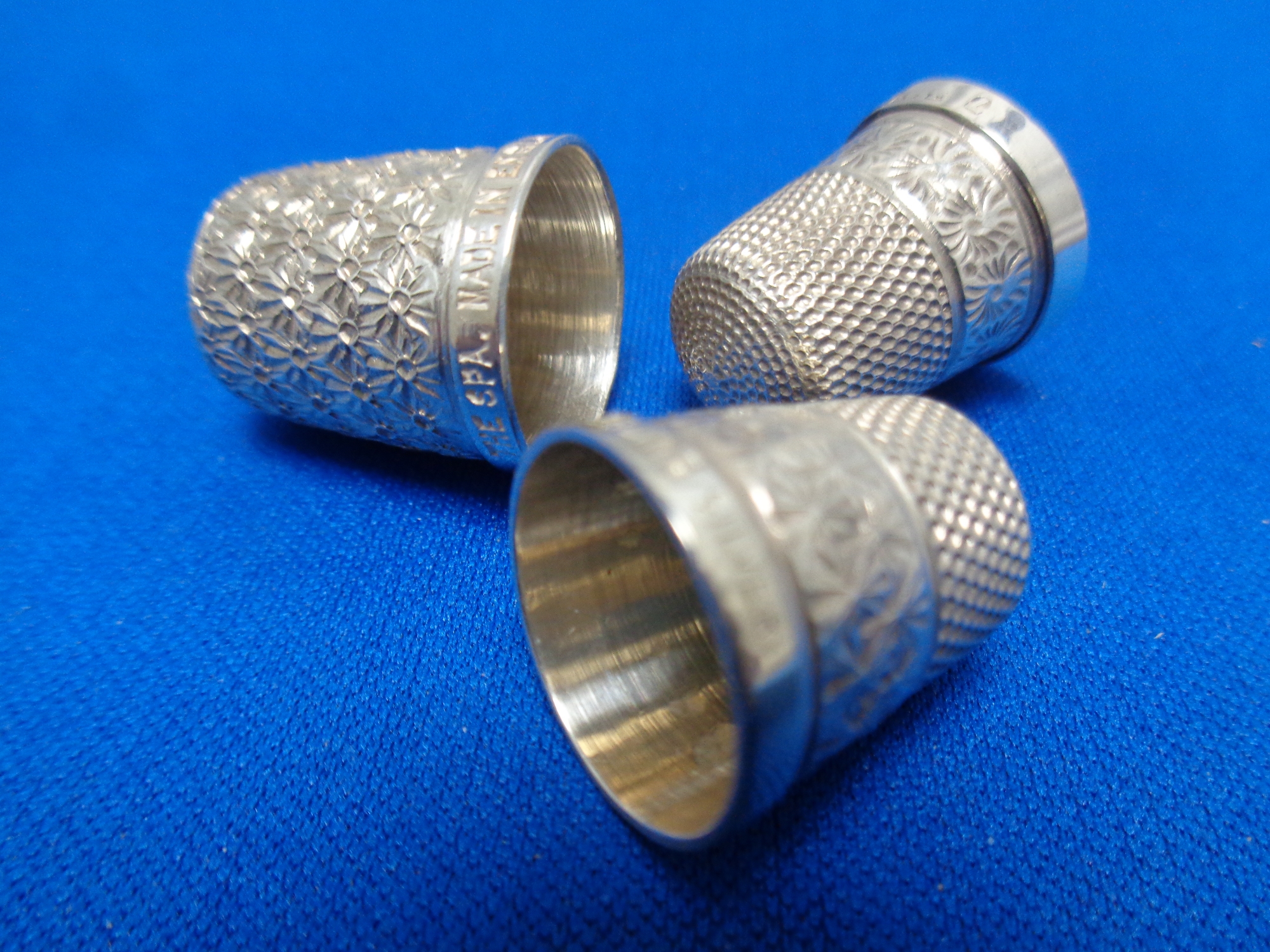 Three silver thimbles