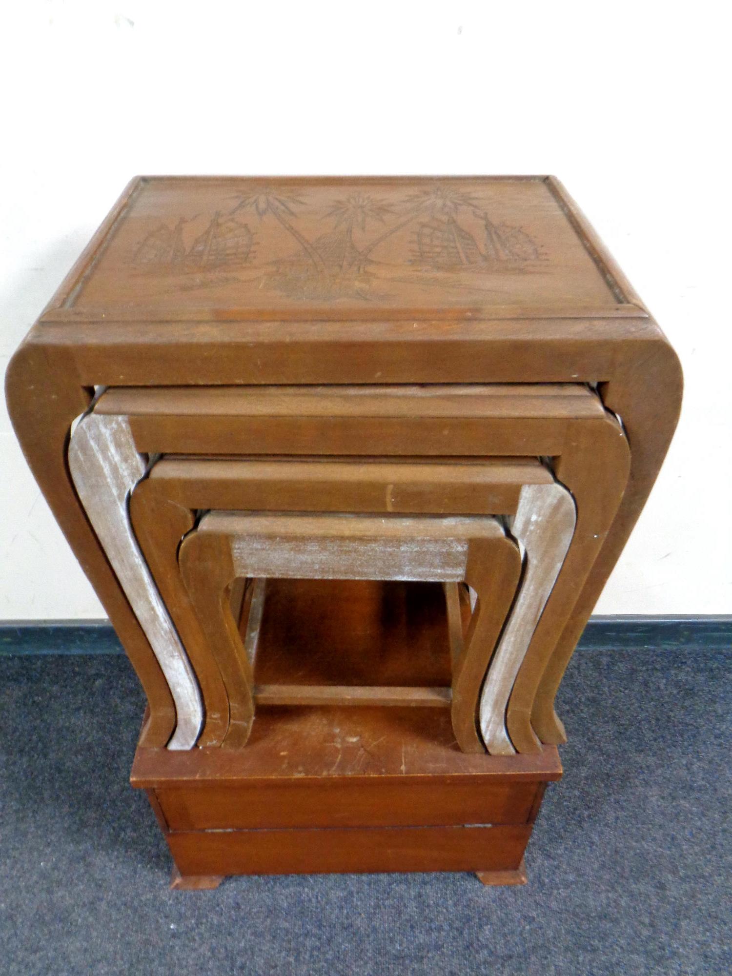 A nest of four oriental style tables together with a wooden stereo box