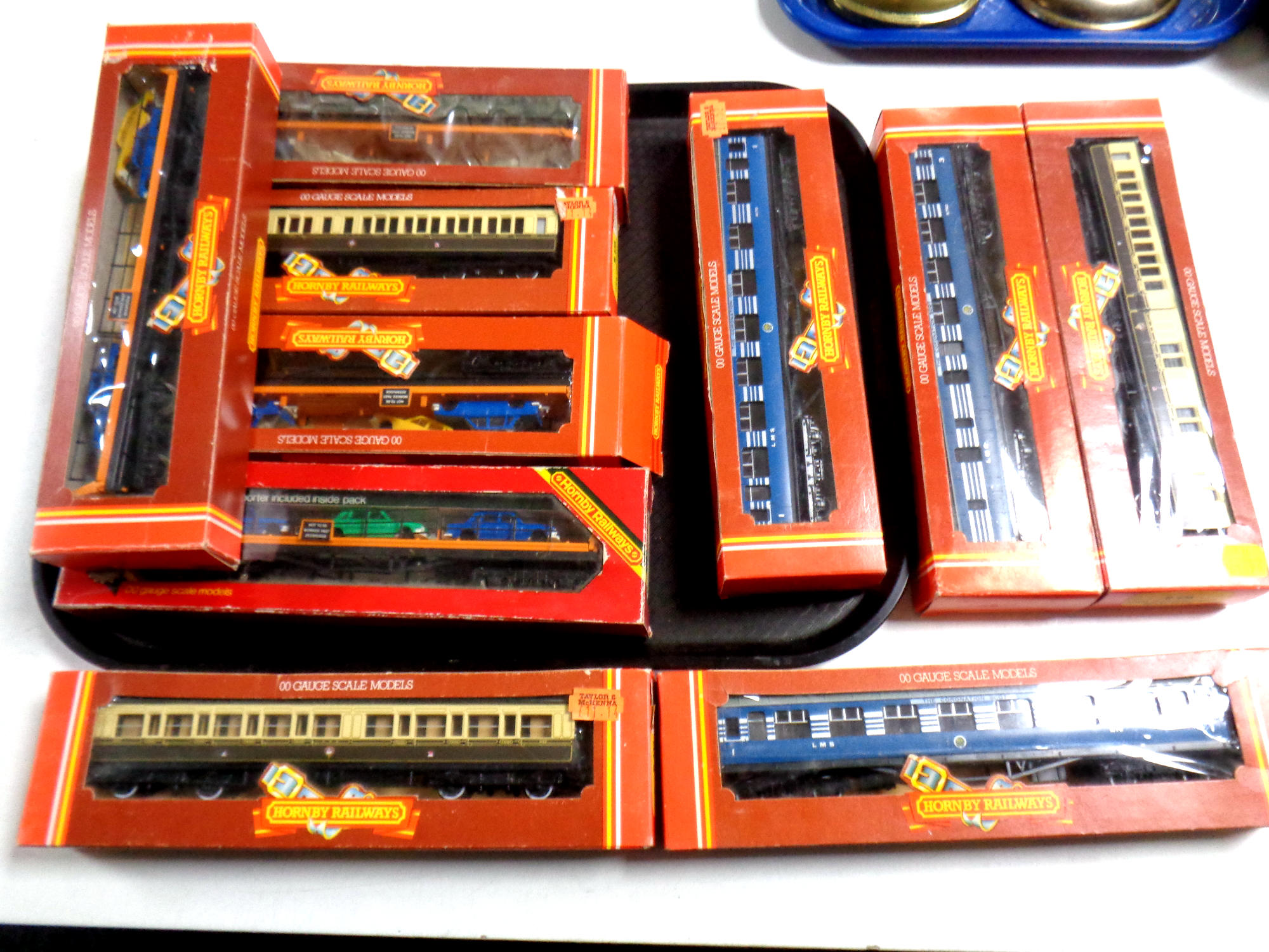 A tray containing Hornby Railways 00 scale coaches and car transporters,