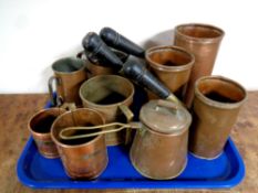 A tray containing antique copper wares to include a set of three copper wooden handled measures,