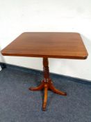 A 19th century tilt top mahogany pedestal occasional table