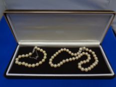 A costume pearl necklace with matching bracelet