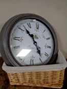 A battery operated French style wall clock and a picnic basket