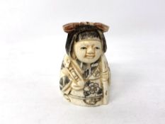 A Chinese carved bone netsuke - young girl in robes