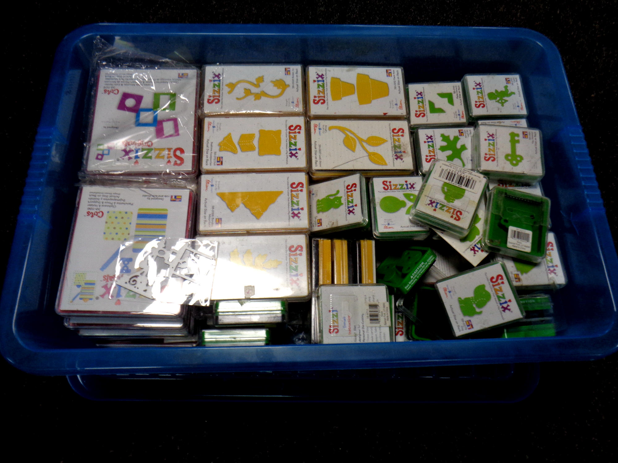 A box containing a large quantity of Sizzix die cutters