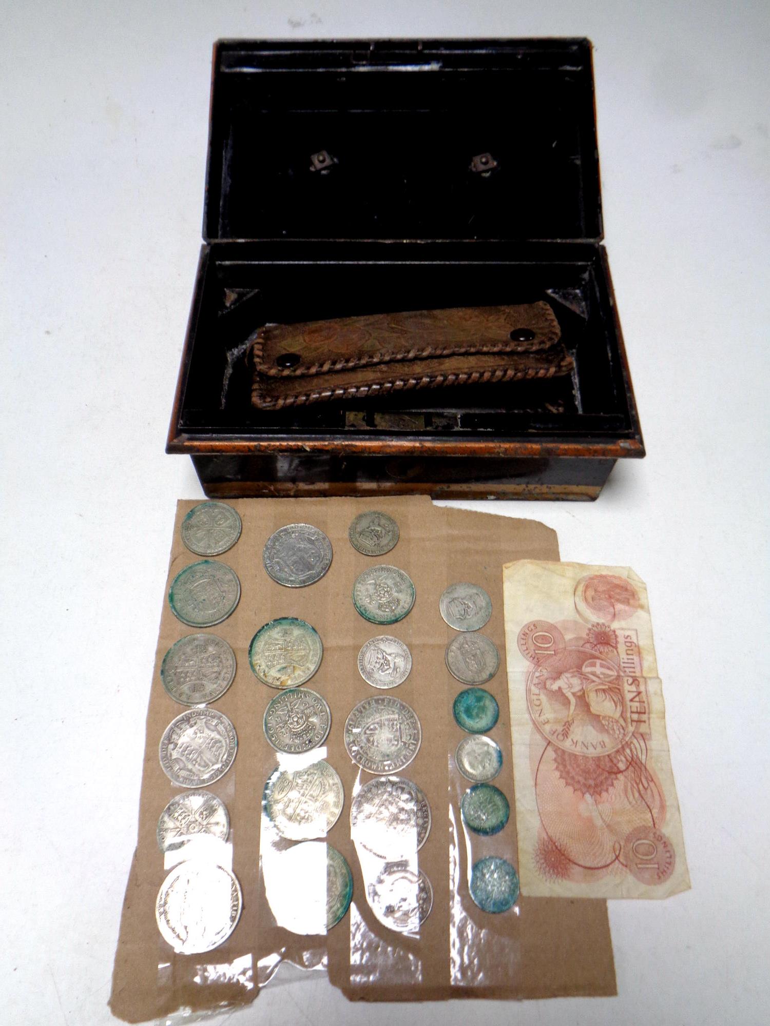 A metal cash box containing leather wallet,