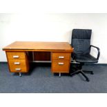 A 20th century teak twin pedestal desk together with a black leather swivel office armchair