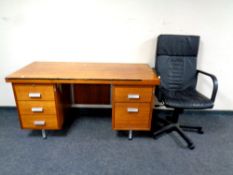 A 20th century teak twin pedestal desk together with a black leather swivel office armchair