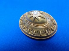 An antique gold circular brooch