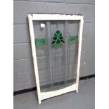 An antique stained glass leaded sash window in frame,