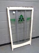 An antique stained glass leaded sash window in frame,