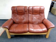 A Stressless wood framed brown leather two seater reclining settee