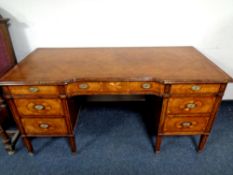 A Regency style breakfront desk fitted seven drawers