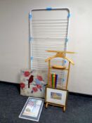 A large folding clothes airer together with a valet stand, a piece of wall art,