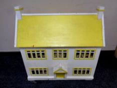 A mid 20th century painted doll's house containing assorted furniture
