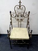 A contemporary wrought iron throne armchair