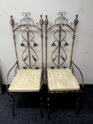 A pair of contemporary wrought iron throne chairs