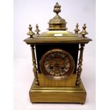 An ornate brass mantel clock on raised feet, with pendulum and key, height 35.
