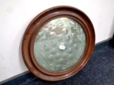 A circular Edwardian etched mirror in a mahogany frame, diameter 49.