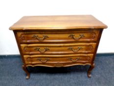 A French walnut serpentine fronted three drawer chest on cabriole legs,